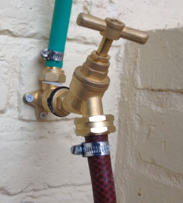 Outside tap with hose fitted