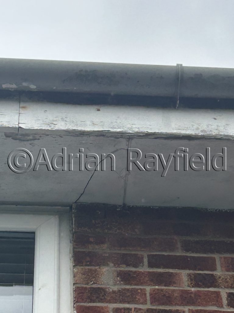 Picture of flacking paint on fascia board and cracked soffit board